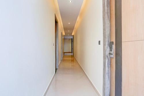 an empty hallway with a hallway leading into a room at Super Townhouse ISBT Dehradun in Dehradun