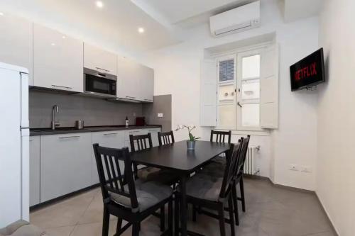 a kitchen with a table and chairs in a room at Pallottole Duomo Apartments in Florence