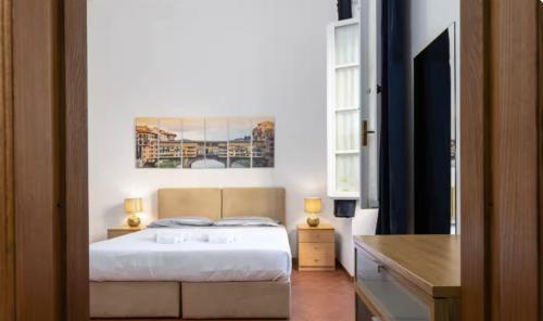 a bedroom with a bed and a painting on the wall at Pallottole Duomo Apartments in Florence