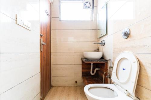 a bathroom with a toilet and a sink at Jasneet Homestay in Amritsar