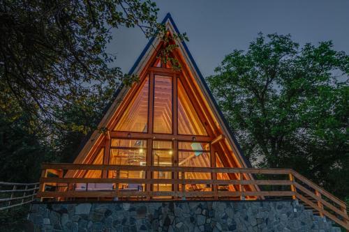 a tree house built on top of a pile of rocks at Old Nut Cabin in Teşila