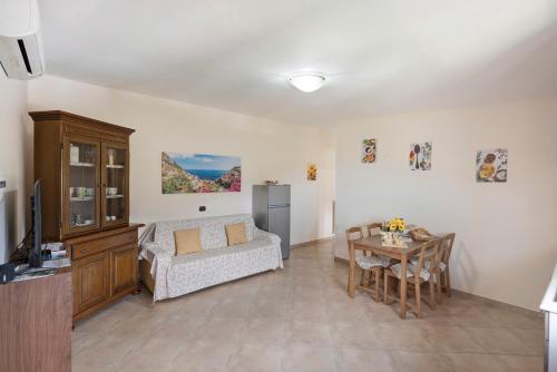 a living room with a couch and a table at Prima Luce in Vico Equense