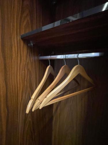 three wooden utensils are hanging on a rack at Italia Hotel cairo in Cairo