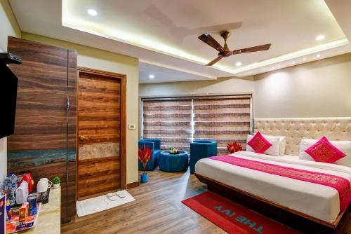a bedroom with a large bed with a ceiling fan at The IVY Grand Hotel - 5 Minutes from Connaught Place and New Delhi Railway Station With Free Secured Parking in New Delhi
