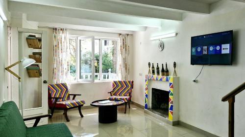 a living room with two chairs and a fireplace at Villa Villekulla in Grigoleti