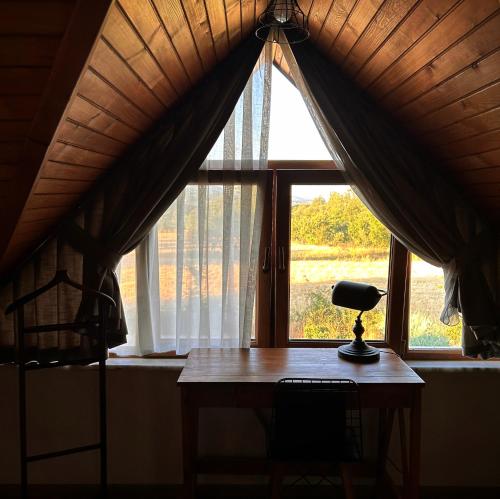 a desk with a lamp in front of a window at Abant Cozy Homes in Bolu