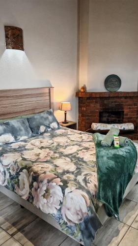 a bedroom with a bed with a blanket on it at Sunbird Studio Apartment in Brackenfell