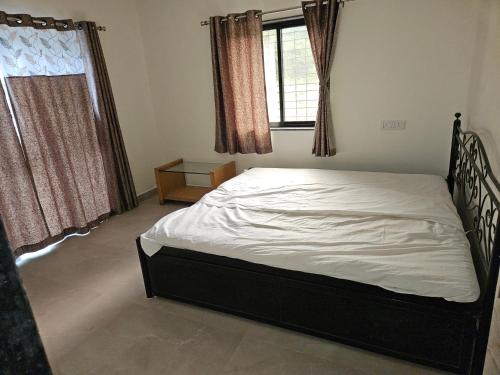 a bedroom with a bed and a window at Rolling Hills in Trimbak