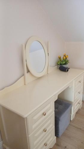 a white dressing table with a mirror on it at Modern Countryside apartment Killmallock Lodge in Enniscorthy