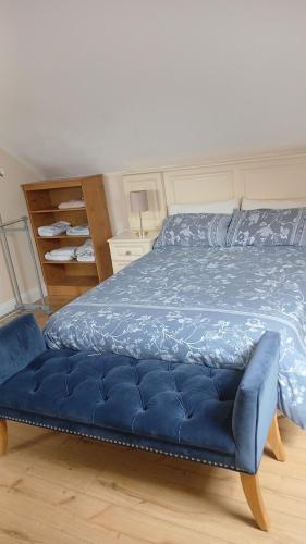 a bedroom with a blue bed with a blue mattress at Modern Countryside apartment Killmallock Lodge in Enniscorthy