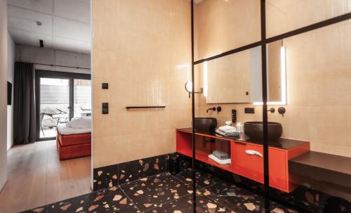 a bathroom with a sink and a mirror at Lifesteil Aparthotel in Umhausen