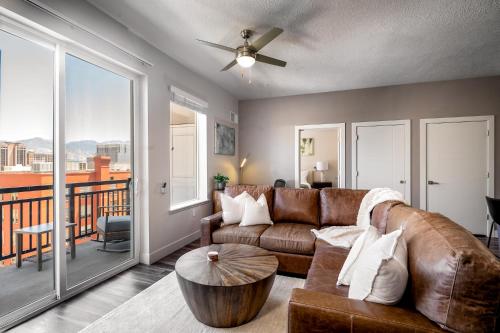 a living room with a couch and a table at Deluxe 2BR Convention Center Gym, Pool, Htub, Pkg in Salt Lake City
