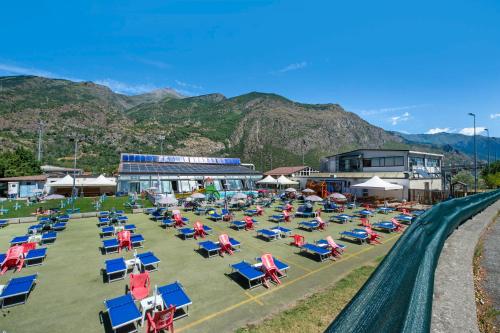 a group of chairs and lawn chairs on a field at Welcome Home 1 Meana di Susa in Meana di Susa