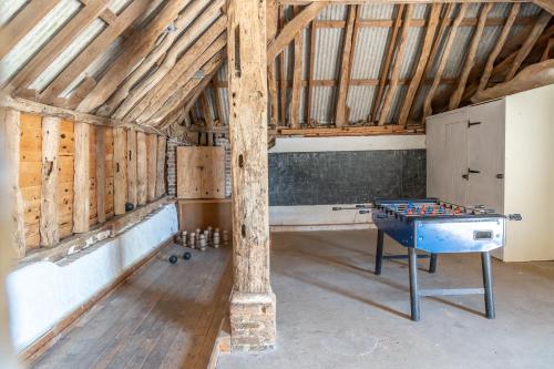 a room with a ping pong table in a barn at Canute Cottages - Cullimers Cottage in Chidham