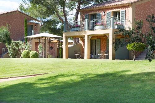 a house with a large lawn in front of it at L'Hôtel & Spa du Castellet in Le Castellet