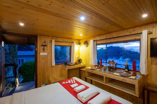 a bathroom with a large window in a cabin at Syamantac Villa in Kodaikānāl
