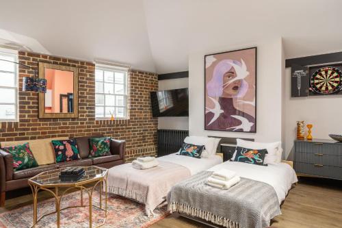 a living room with two beds and a couch at Fun Kemptown Stay with Games Close To Seafront in Brighton & Hove