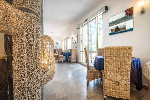 a dining room with chairs and a table in a room at Hotel Piccolo Mondo in Acquappesa