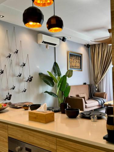 a kitchen with a living room with a couch at The JB House - A 5 Star Quality Home At Iskandar Puteri in Gelang Patah