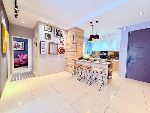 a kitchen with a counter and stools at The JB House - A 5 Star Quality Home At Iskandar Puteri in Gelang Patah