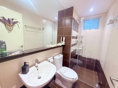 a bathroom with a toilet and a sink at The JB House - A 5 Star Quality Home At Iskandar Puteri in Gelang Patah