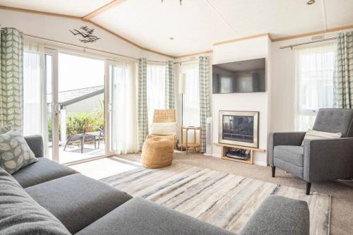 a living room with a couch and a fireplace at The Woodlark in Poole