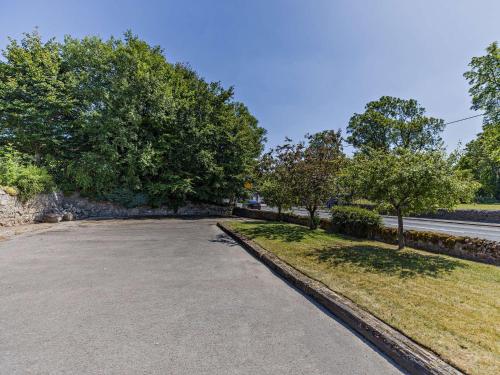an empty parking lot with trees and a road at 7 Bed in Waterhouses 81529 in Waterhouses
