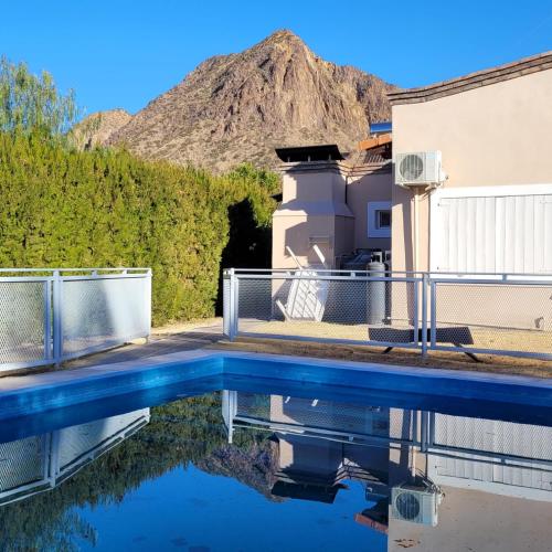 a pool of water with a mountain in the background at CASA EN VALLE GRANDE Country Club Solar Del Valle in San Rafael