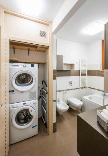 a bathroom with a washer and dryer in it at Attico vista mare con Jacuzzi - CASA LUXURY DIAMANTE in Ortona