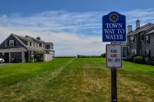 a street sign in front of a house at Waterfront Walk to Beach in Barnstable