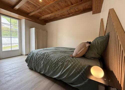 a woman laying on a bed in a bedroom at Gliget in Lourdios-Ichère