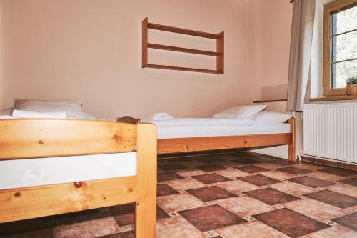 a bedroom with two bunk beds and a window at Penzion pod Šerákem in Ostružná