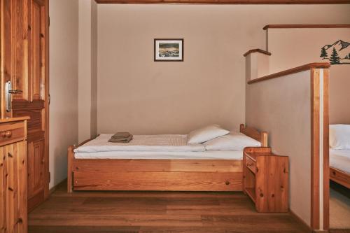 a bedroom with a bed and a bunk bed at Penzion pod Šerákem in Ostružná