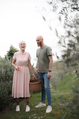 a man and a woman standing in a field with a basket at Casa Montalgallo in Lucignano