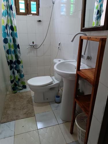 a bathroom with a toilet and a sink at Jambiani Holiday Villa in Jambiani