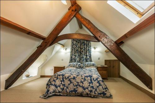 a bedroom with a canopy bed in a attic at Betws Bach in Criccieth