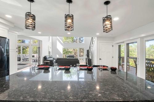 a living room with a table and a couch at Modern Wellfleet Retreat with Stunning Outdoor Spaces in Wellfleet