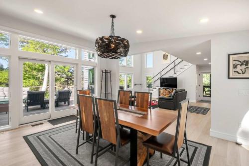 a dining room and living room with a table and chairs at Modern Wellfleet Retreat with Stunning Outdoor Spaces in Wellfleet