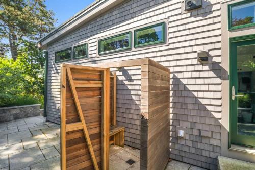 a door in the side of a house at Modern Wellfleet Retreat with Stunning Outdoor Spaces in Wellfleet