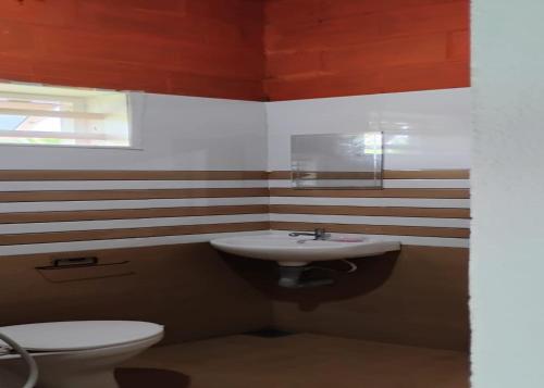 a bathroom with a sink and a toilet at Kadavath Homestay in Ernakulam