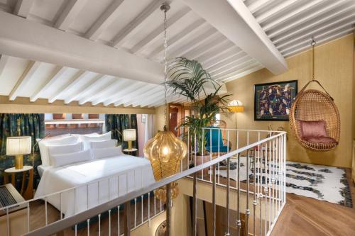a bedroom with a white bed and a balcony at The James Suite Hotel Firenze 1564 - Small Luxury Hotels of the World in Florence