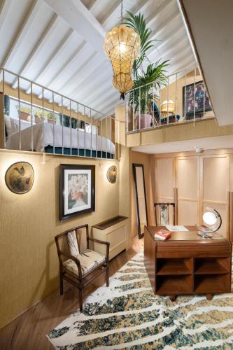 a living room with a table and a chair at The James Suite Hotel Firenze 1564 - Small Luxury Hotels of the World in Florence