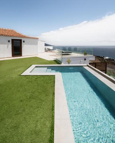 a swimming pool in the backyard of a house at V&C Luxury Village in Breña Baja