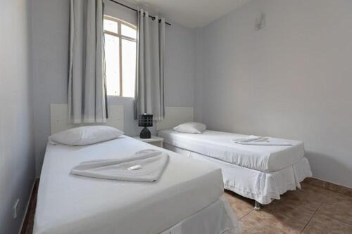 Ένα ή περισσότερα κρεβάτια σε δωμάτιο στο Iguassu Flats Hotel