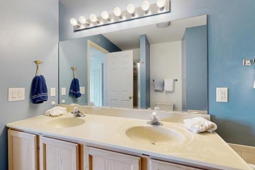 a bathroom with a sink and a large mirror at Bethany Marina --- 38249 Yacht Basin Rd #22 in Ocean View