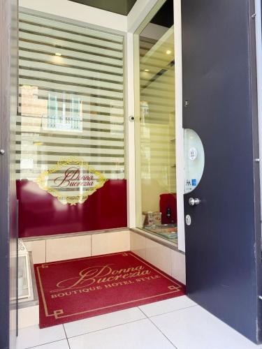 a door to a store with a red rug in front at DONNA LUCREZIA b&b Boutique Hotel Style - relax & business stay in Bisceglie
