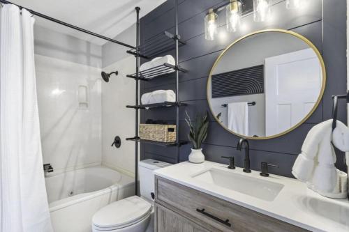 a bathroom with a sink and a mirror and a tub at The Lookout at Kimberling Crossing in Kimberling City