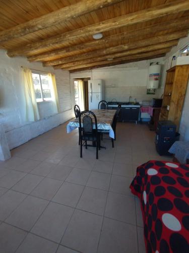 a room with a table and chairs in a house at Vista los Andes in Cacheuta