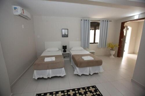 Ένα ή περισσότερα κρεβάτια σε δωμάτιο στο Iguassu Flats Hotel