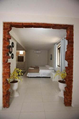 Ένα ή περισσότερα κρεβάτια σε δωμάτιο στο Iguassu Flats Hotel